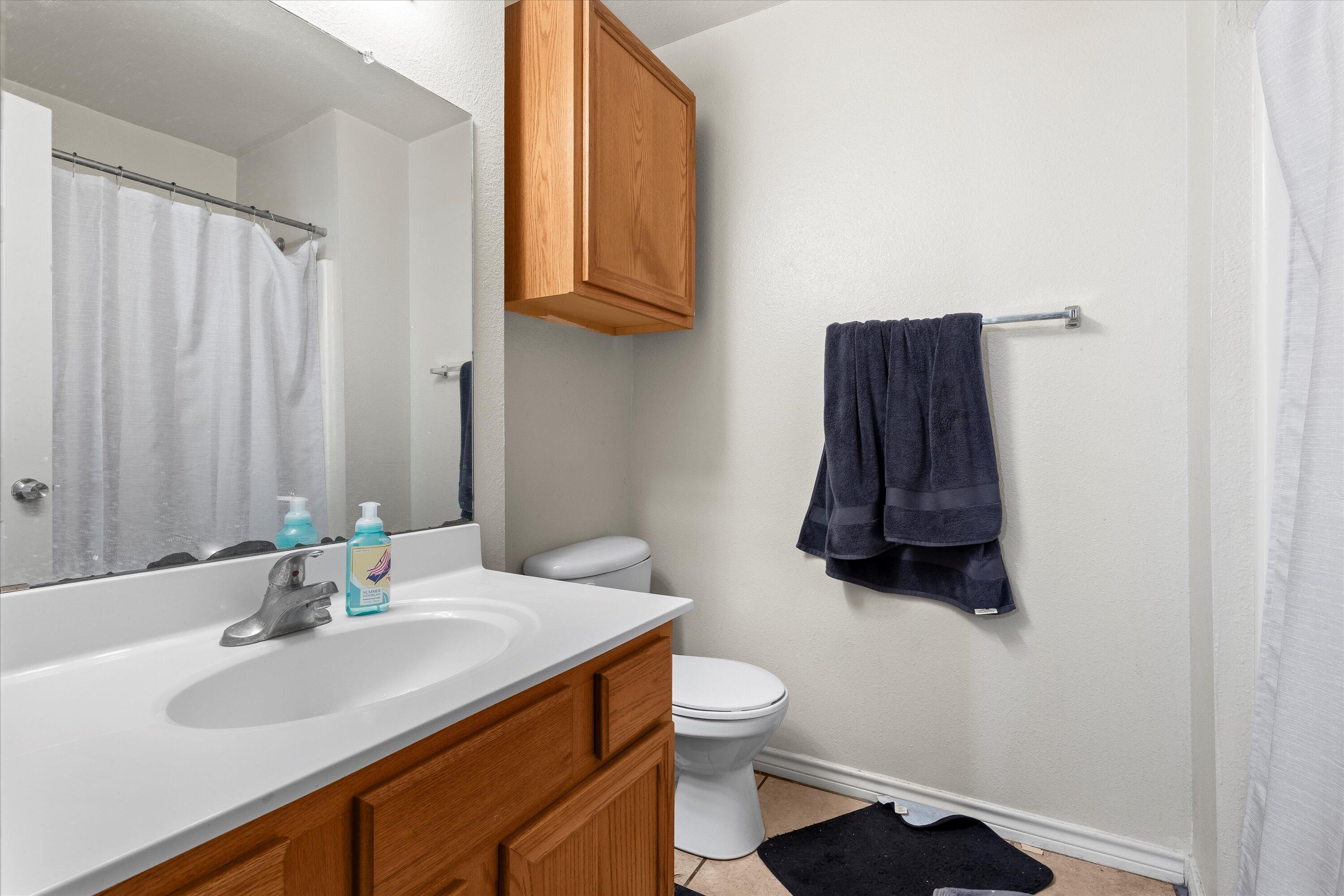 5423 Marshall Street Lubbock, TX 79416 - Photo 21 of 25 a bathroom with a sink toilet and shower