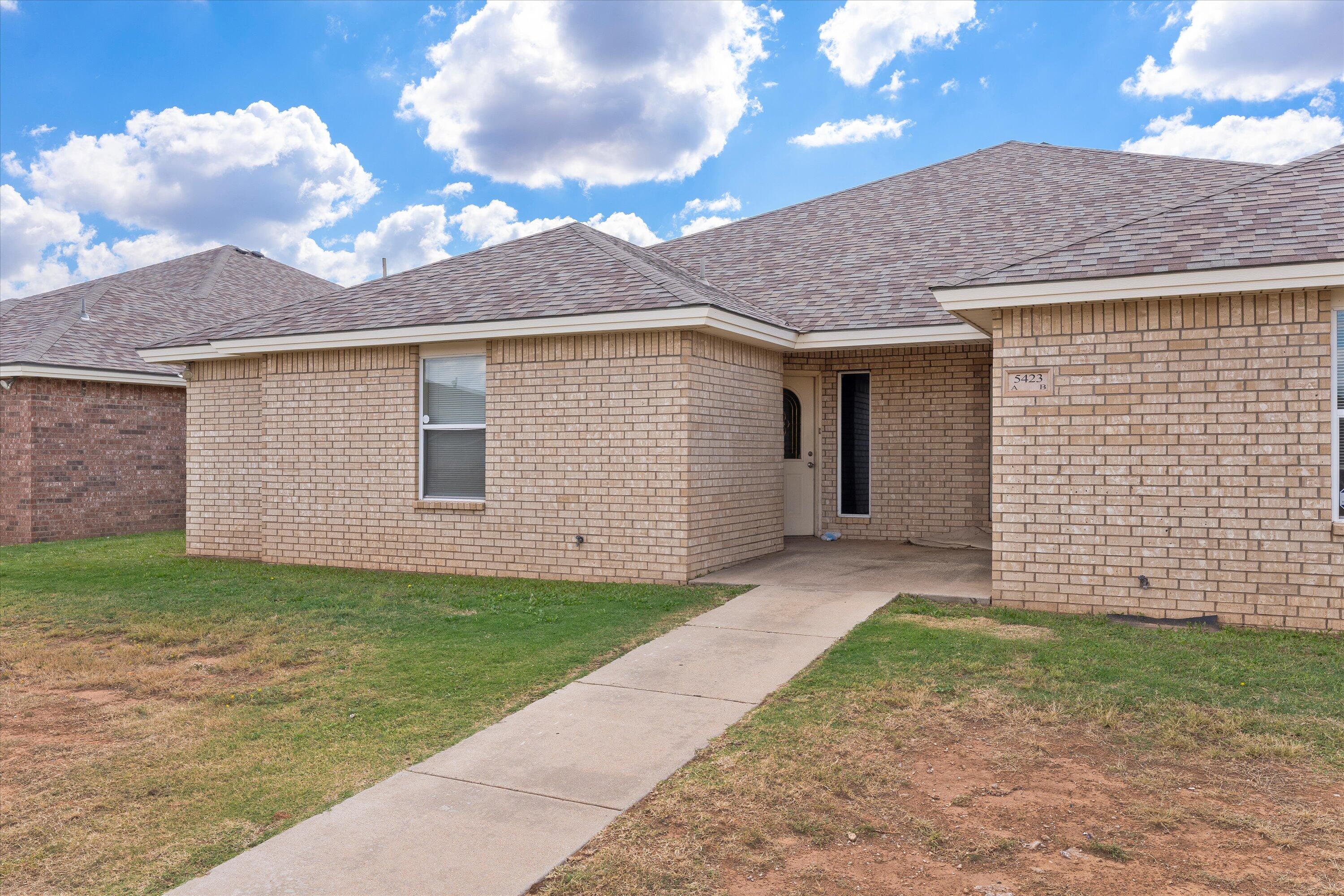5423 Marshall Street Lubbock, TX 79416 - Photo 3 of 25 a front view of a house with a yard