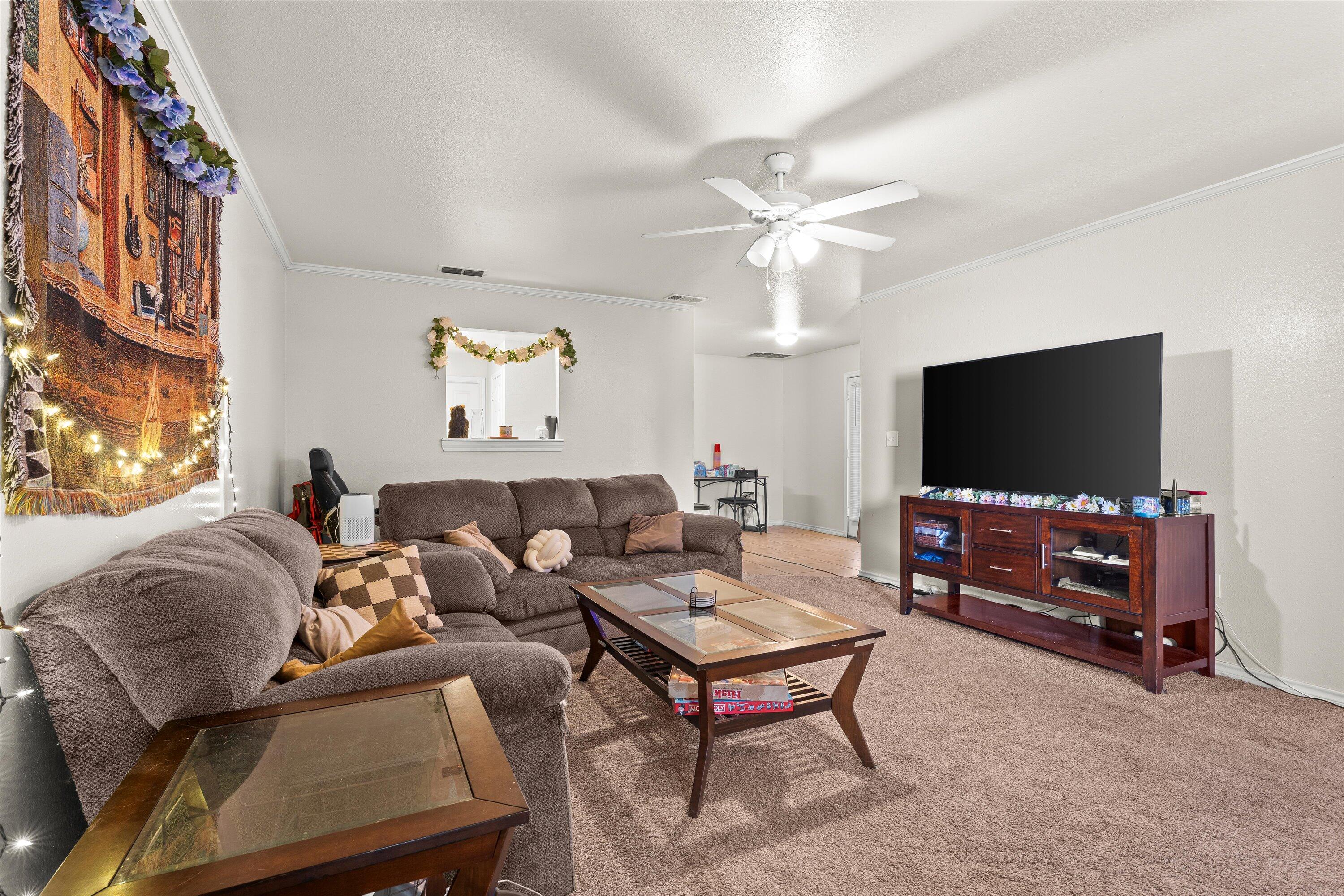 5423 Marshall Street Lubbock, TX 79416 - Photo 7 of 25 a living room with furniture and a flat screen tv