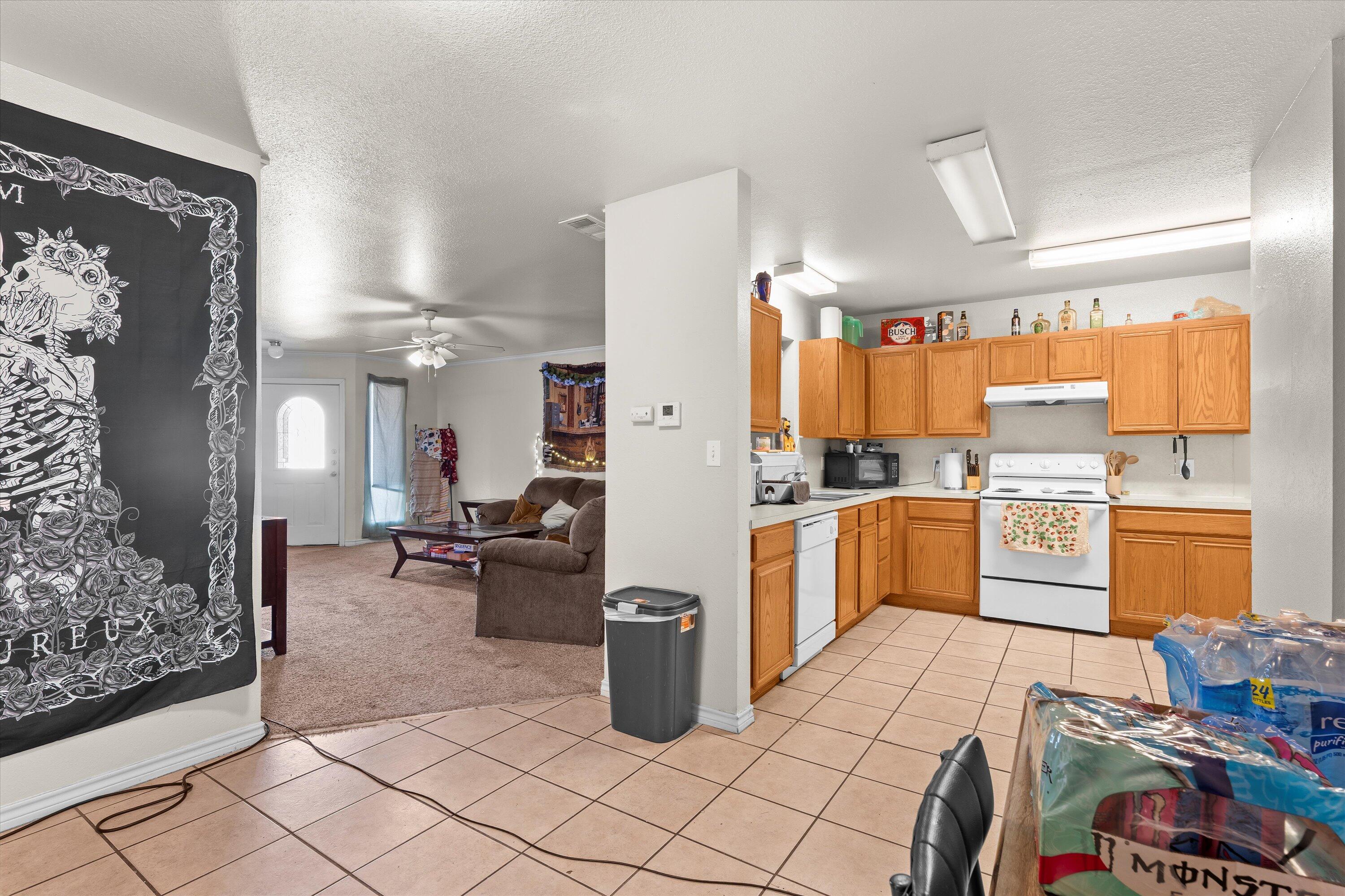 5423 Marshall Street Lubbock, TX 79416 - Photo 8 of 25 a kitchen with refrigerator and cabinets