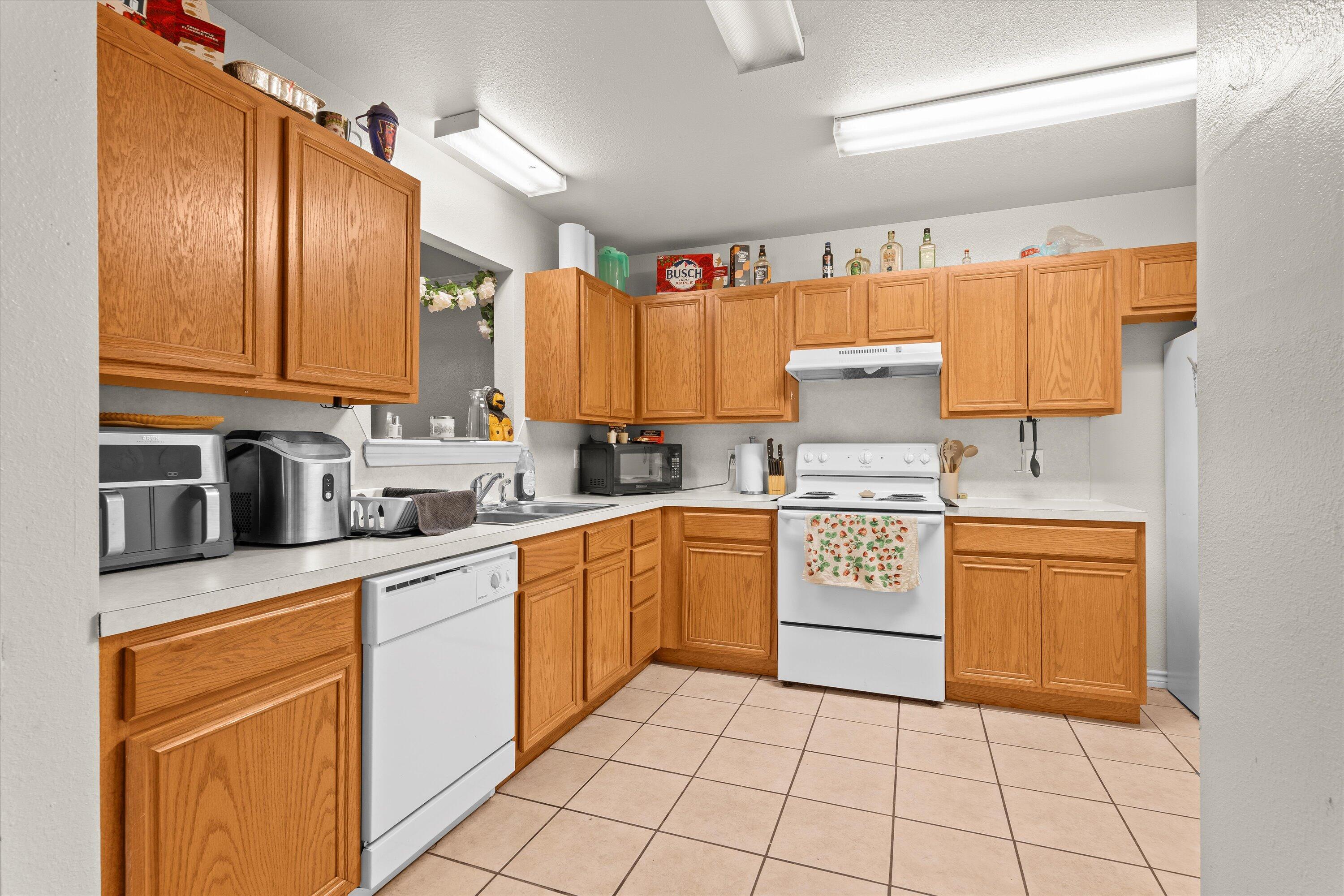 5423 Marshall Street Lubbock, TX 79416 - Photo 9 of 25 a kitchen with stainless steel appliances granite countertop a sink and cabinets