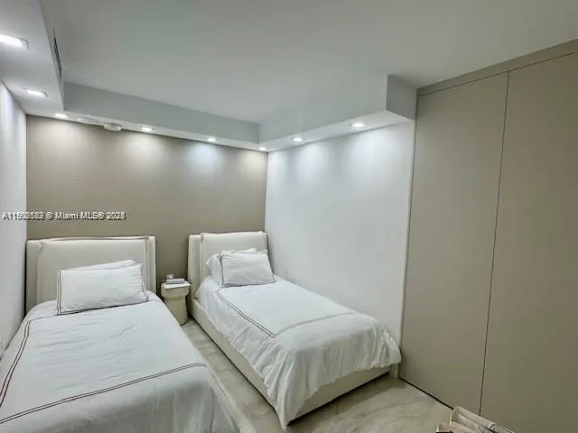 a bedroom with a bed and a night stand