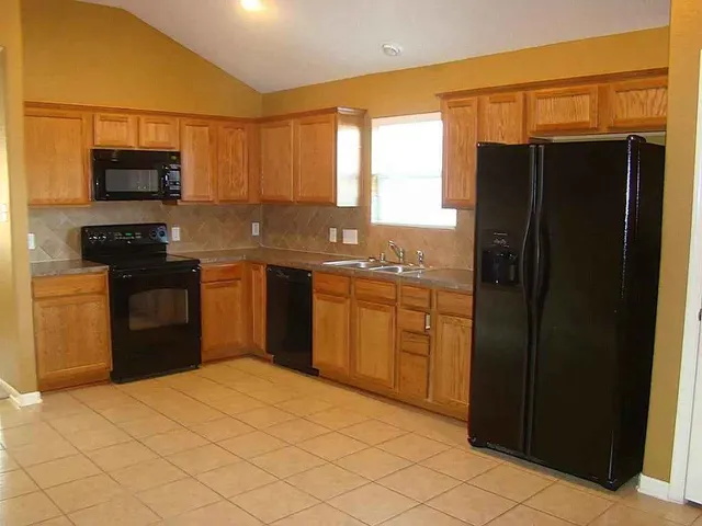 a kitchen with stainless steel appliances a refrigerator and a stove
