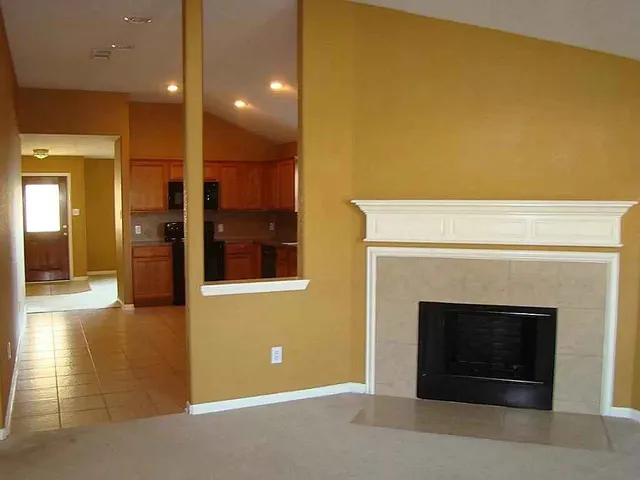 a view of an empty room with a fireplace