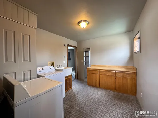 a view of a kitchen with storage and utility