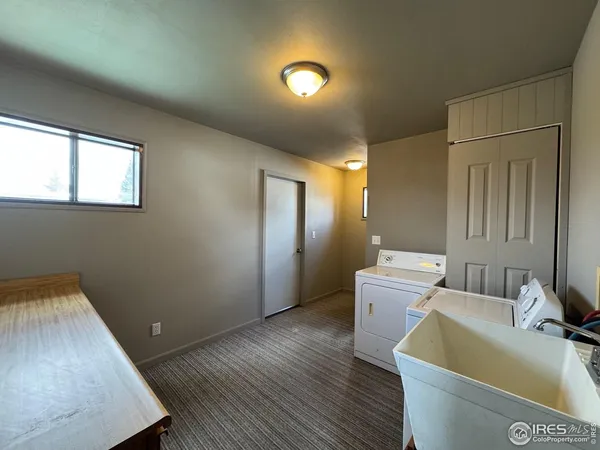 a room with a sink and a wooden floor