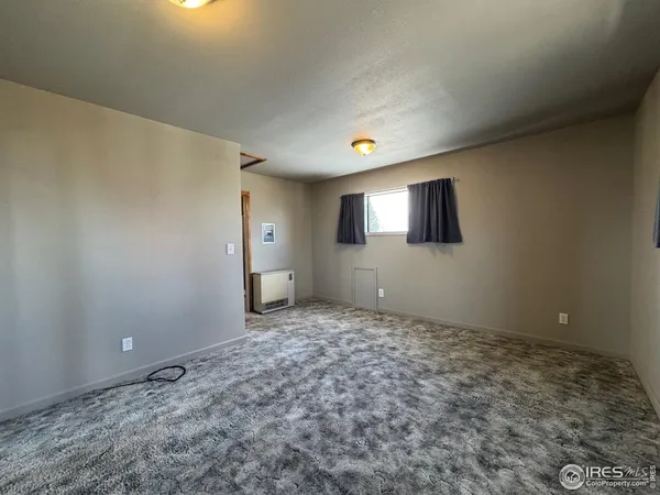 a view of an empty room and window