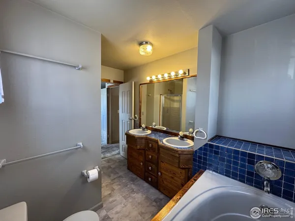 a bathroom with a sink mirror and toilet