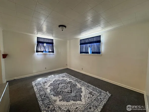 an empty room with a rug