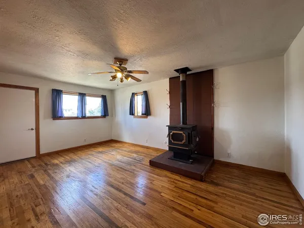 a view of an empty room and wooden floor