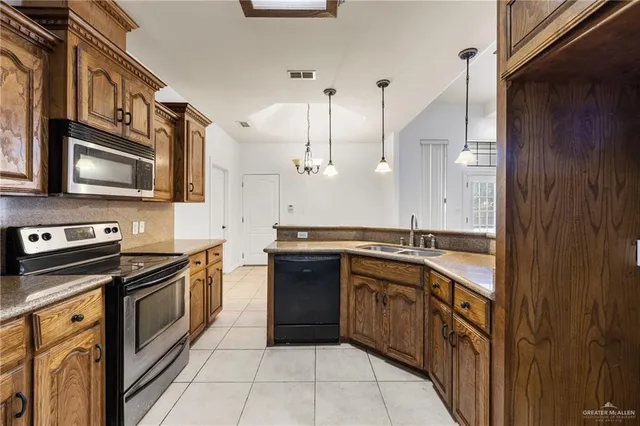 a kitchen with stainless steel appliances granite countertop a sink and stove top oven