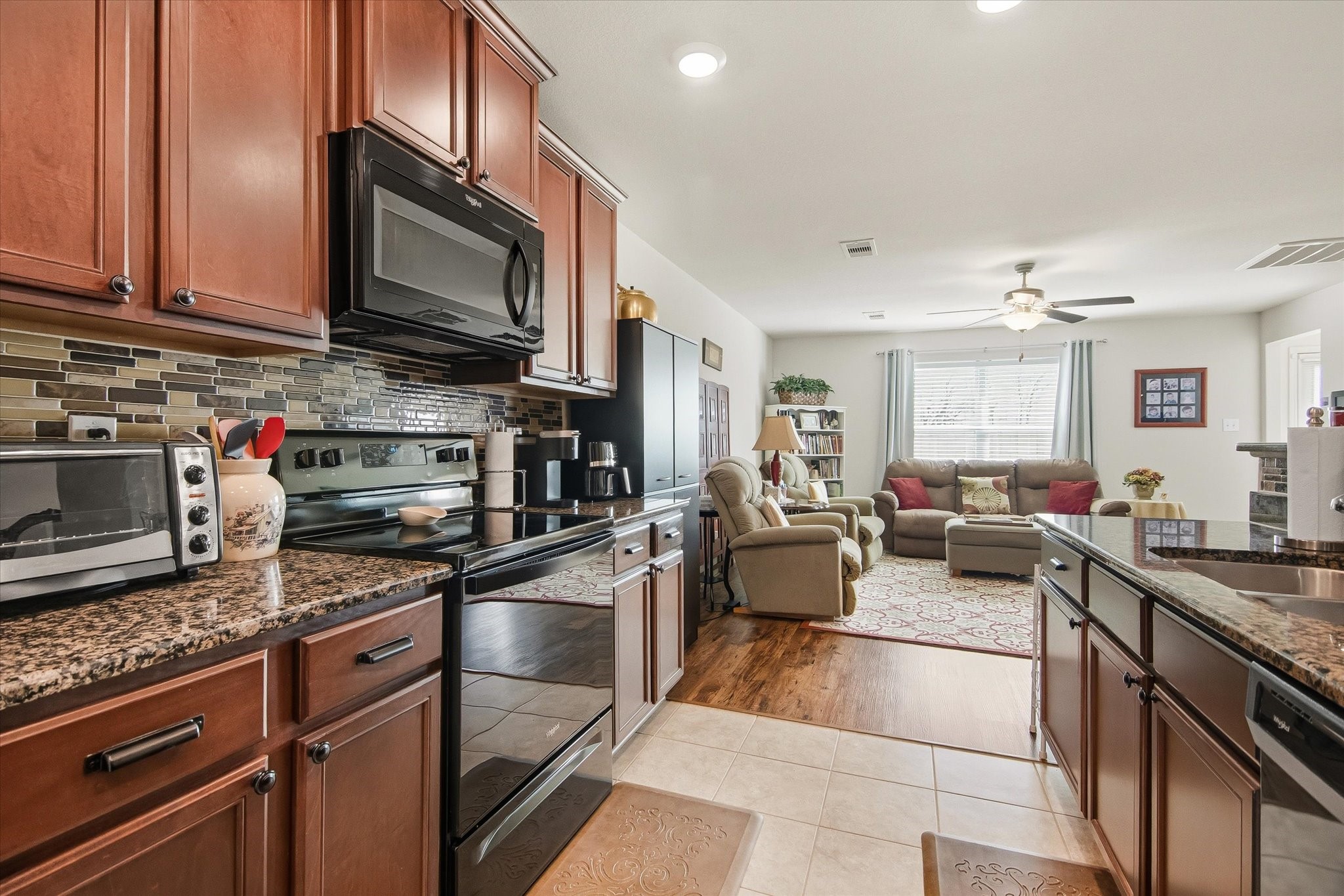 1306 Paradise Found Drive Rosharon, TX 77583 - Photo 19 of 36 a kitchen with stainless steel appliances granite countertop a sink dishwasher stove and oven with cabinets
