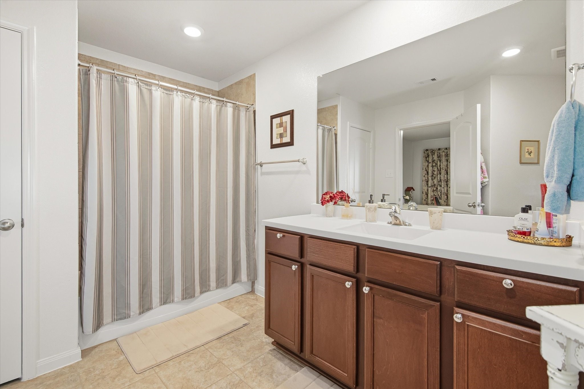 1306 Paradise Found Drive Rosharon, TX 77583 - Photo 27 of 36 a bathroom with a double vanity sink and mirror
