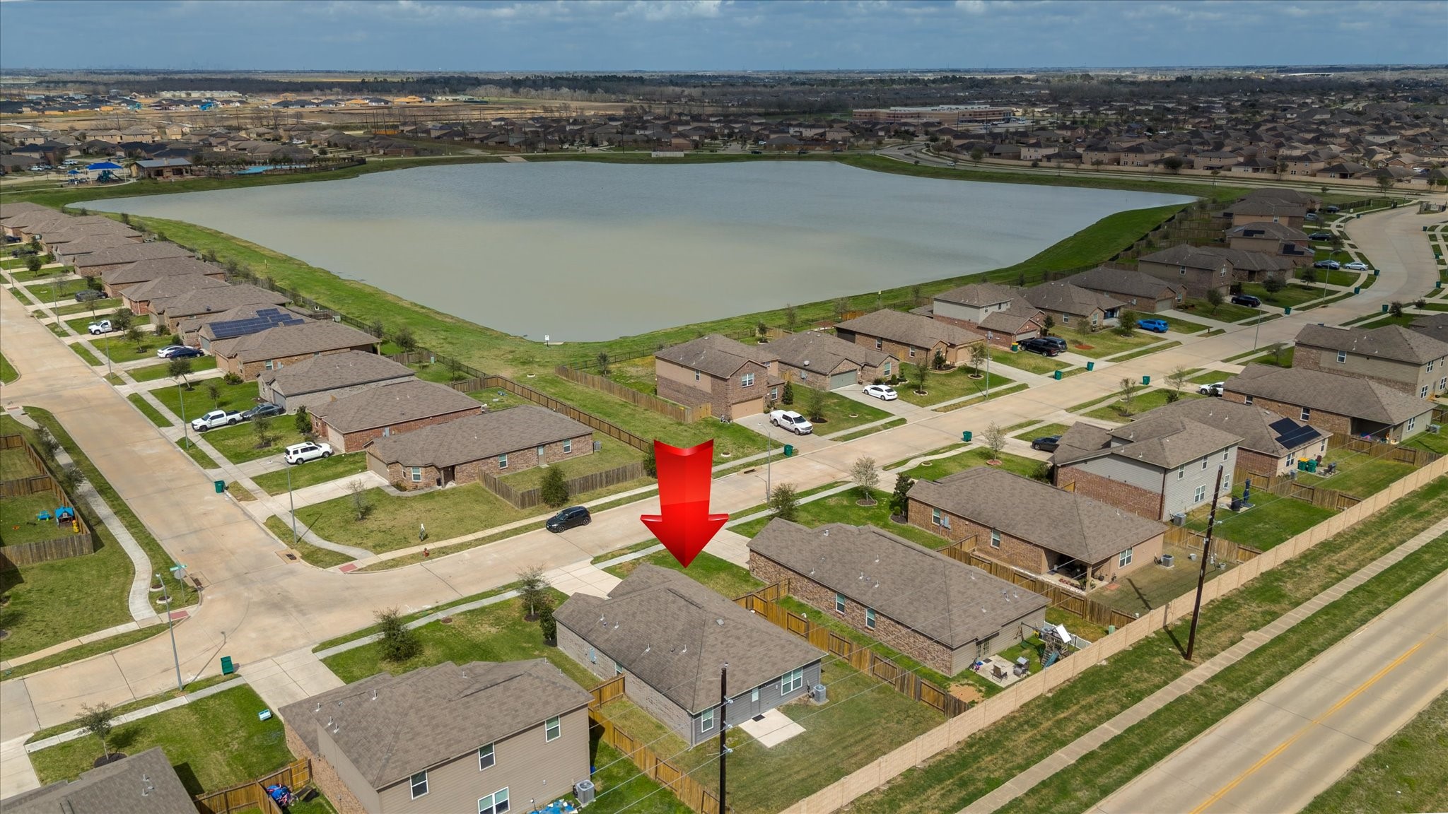 1306 Paradise Found Drive Rosharon, TX 77583 - Photo 34 of 36 an aerial view of a house with a lake