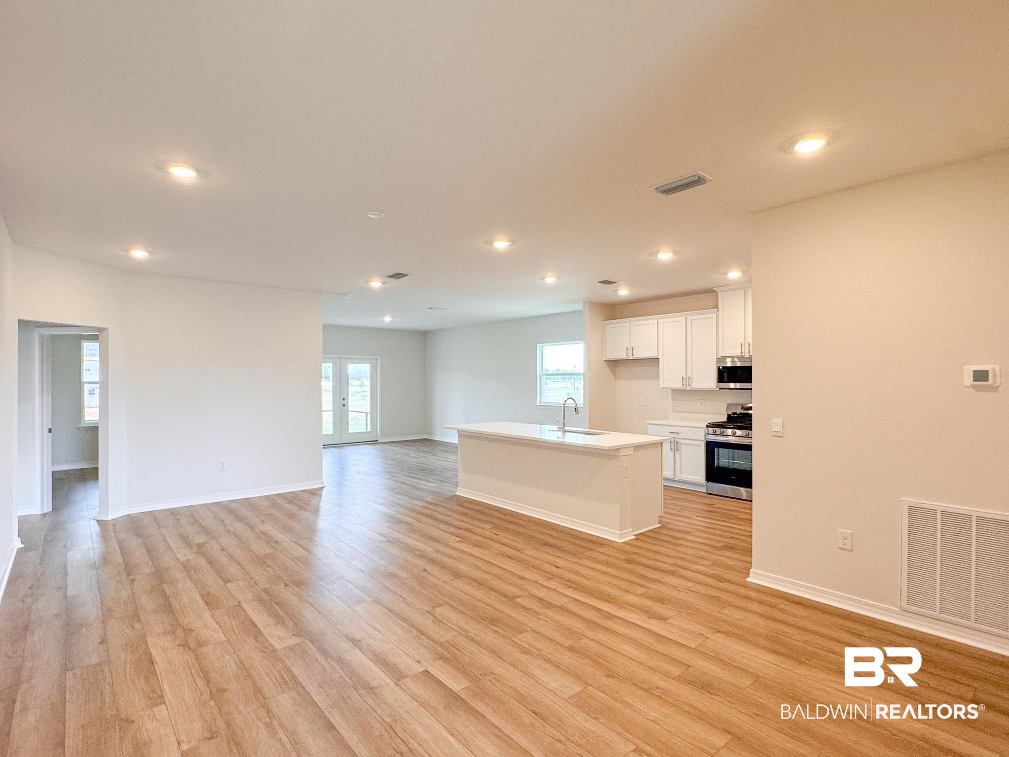 18151 Kent Circle Foley, AL 36535 - Photo 4 of 25 Open-concept living area featuring wood-finish flooring, recessed lighting, and a neutral color palette