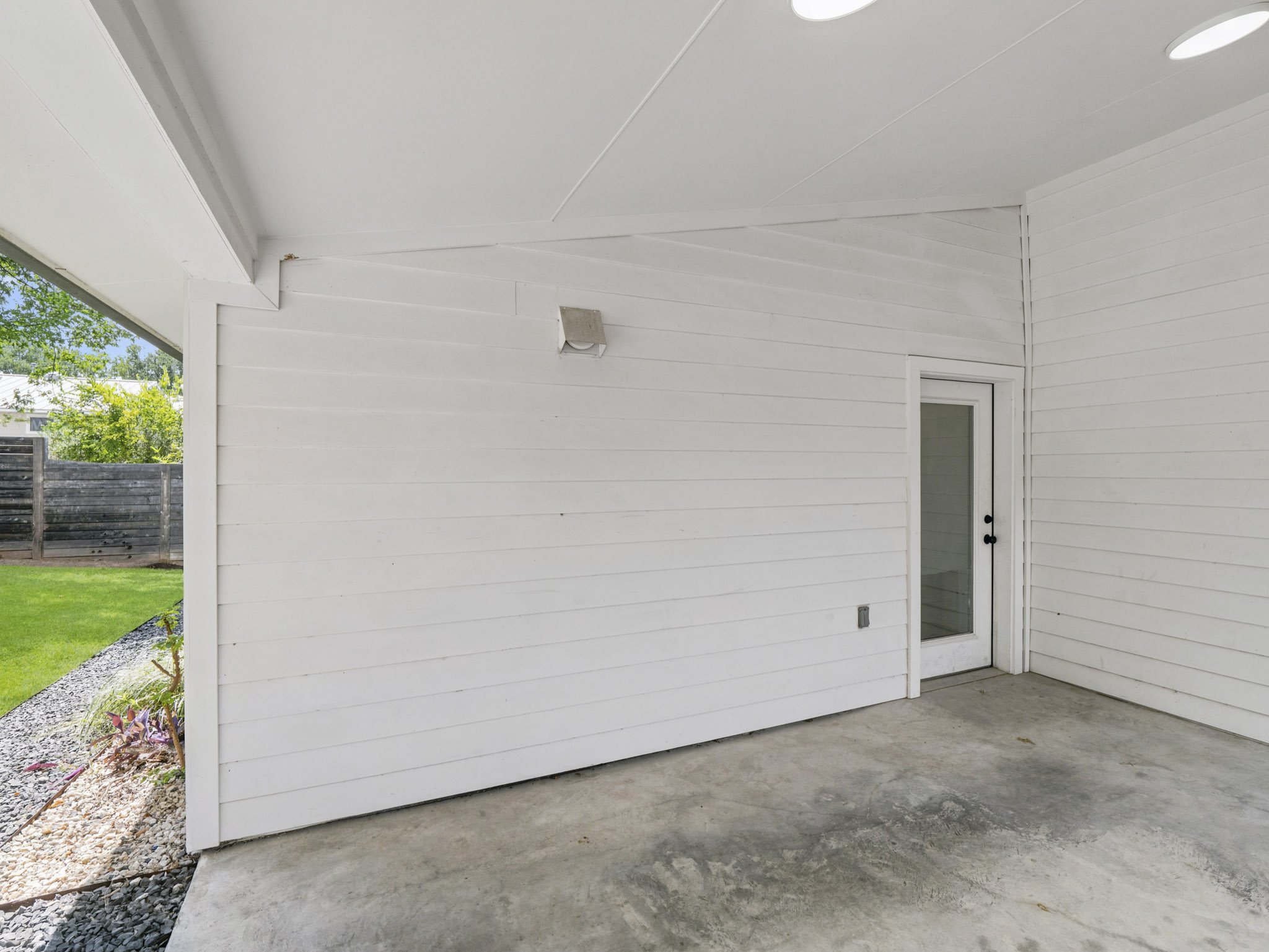 5005 Lott Avenue, Unit 2 Austin, TX 78721 - Photo 20 of 25 A private covered patio extends to a well-maintained lawn, perfect for serene outdoor moments.