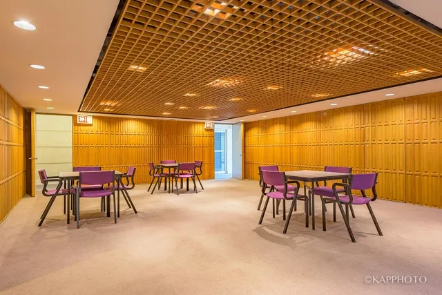 a dining room with furniture and a potted plant