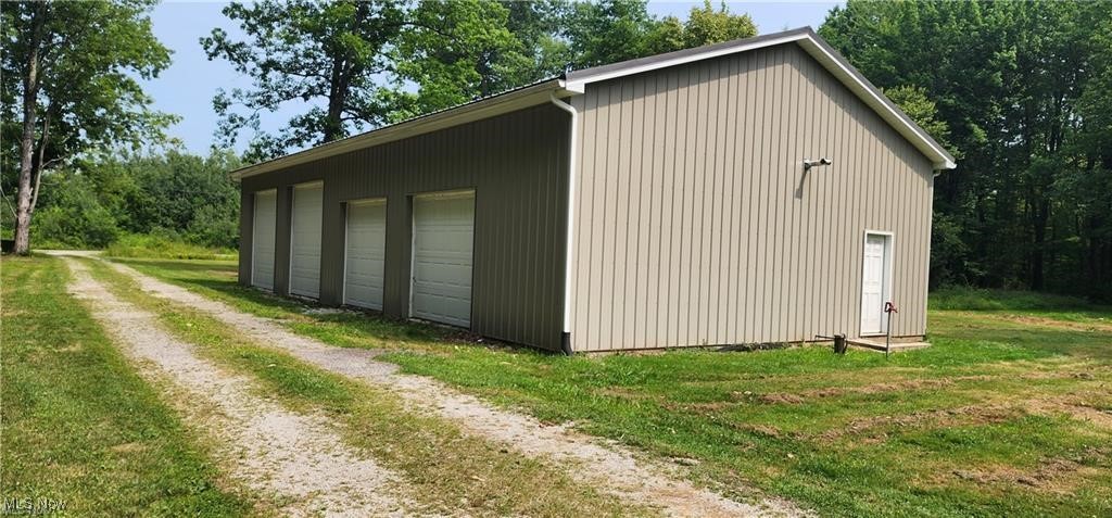 6699 Howard Road Williamsfield, OH 44093 - Photo 3 of 31 View of outbuilding with a garage and a yard