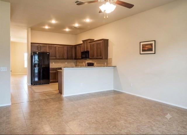 415 Harding Lane Lavon, TX 75166 - Photo 5 of 13 Open-concept kitchen and living area featuring tile flooring, dark wood cabinetry, a breakfast bar, recessed lighting, and a ceiling fan
