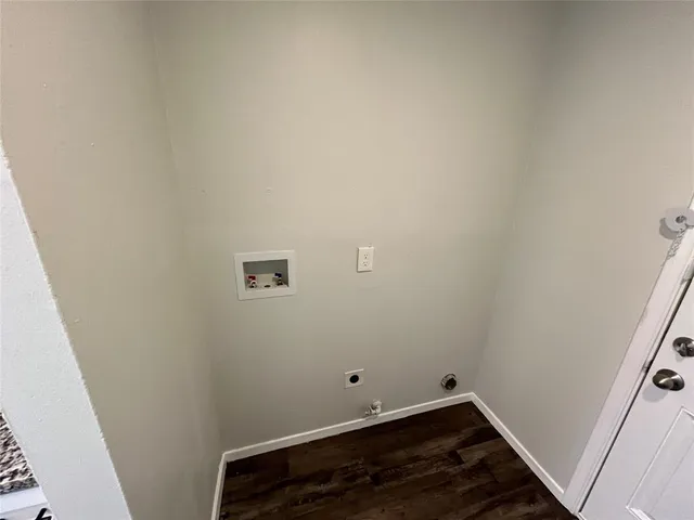 a room with a wooden floor and white walls