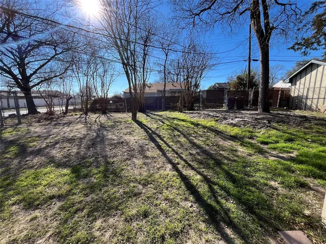 a view of a yard with snow on the road