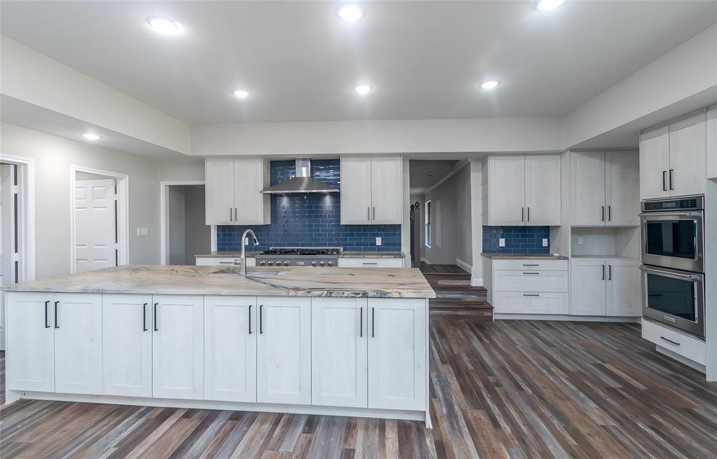 13 Crestview Circle Rockwall, TX 75087 - Photo 13 of 37 a kitchen with stainless steel appliances granite countertop a stove a sink and white cabinets