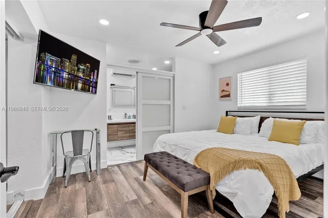 a bedroom with a bed and a flat screen tv