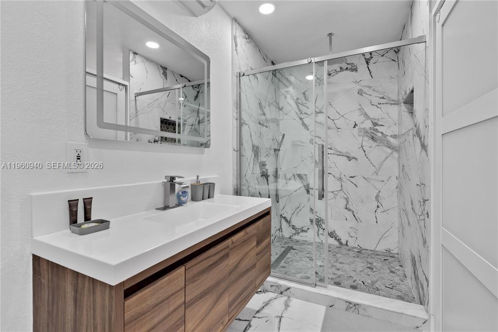7831 Hope Street Hollywood, FL 33024 - Photo 10 of 19 a bathroom with a sink and a mirror
