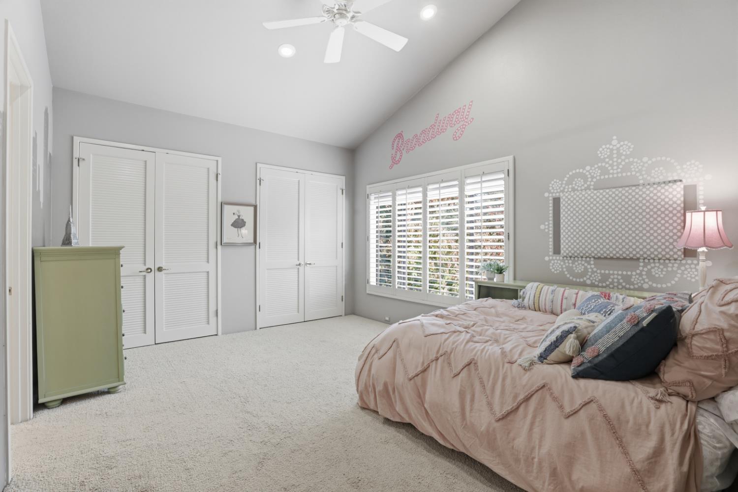 11575 Splitrock Court Gold River, CA 95670 - Photo 22 of 90 a spacious bedroom with a bed a chandelier and a large window