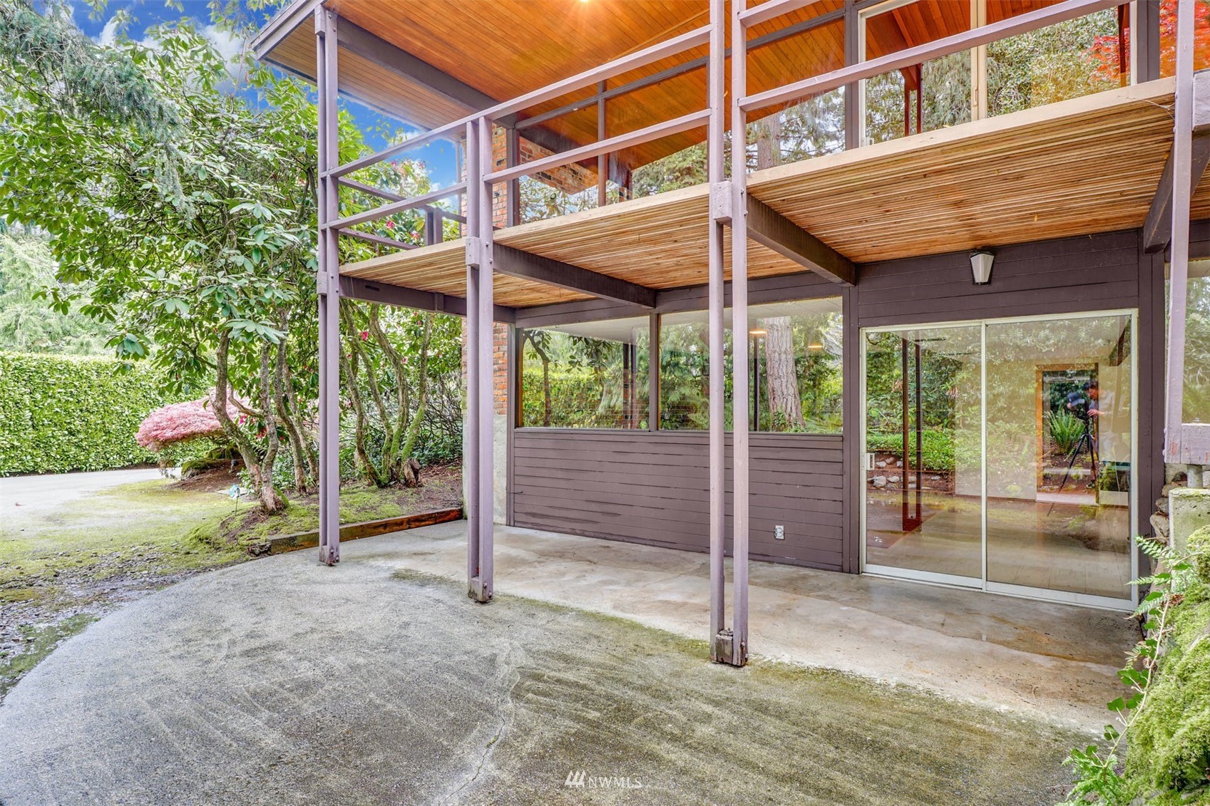 3309 Evergreen Point Road Medina, WA 98039 - Photo 19 of 25 a view of a house with a porch and floor to ceiling windows
