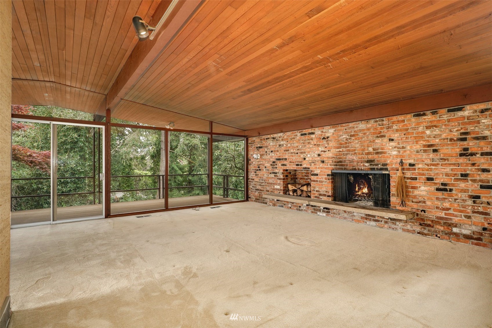 3309 Evergreen Point Road Medina, WA 98039 - Photo 7 of 25 a view of an empty room with a fireplace and a large window