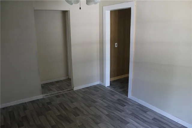an empty room with wooden floor and closet