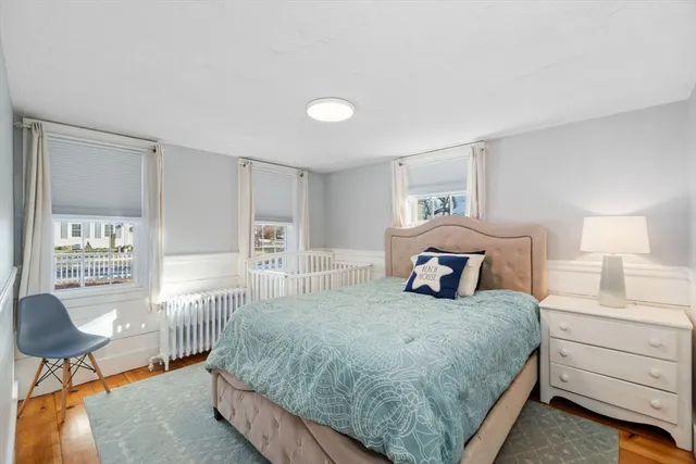 a bedroom with a large bed and a chandelier