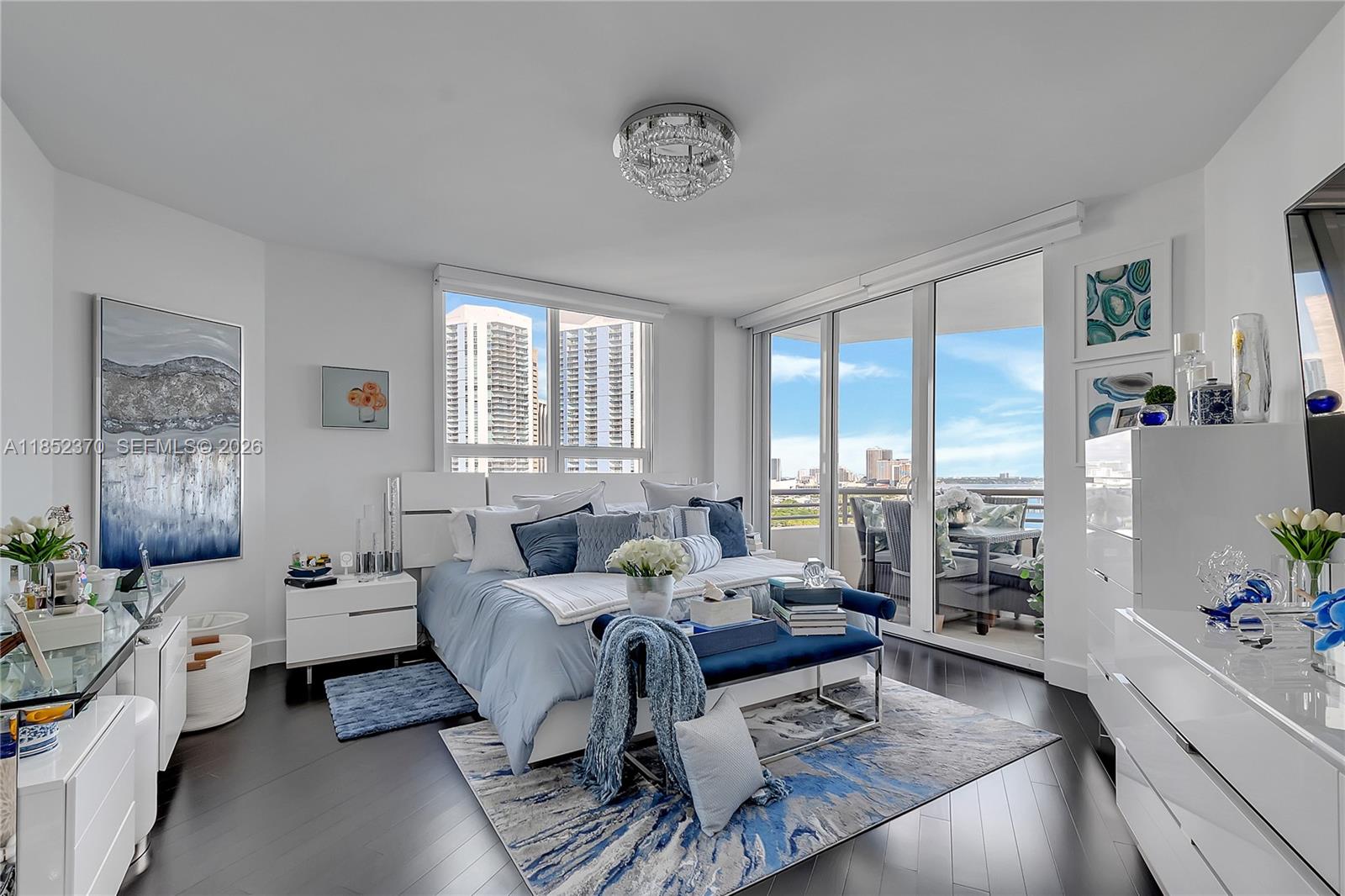 848 Brickell Key Drive, Unit 1906 Miami, FL 33131 - Photo 14 of 24 a living room with furniture and a large window