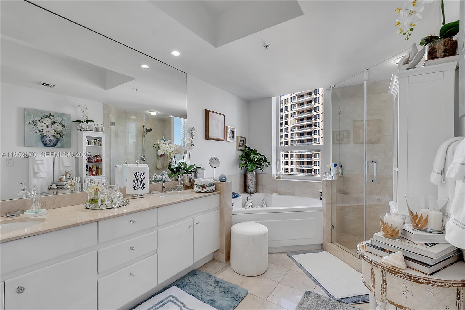 848 Brickell Key Drive, Unit 1906 Miami, FL 33131 - Photo 14 of 18 a bathroom with a double vanity sink toilet and shower