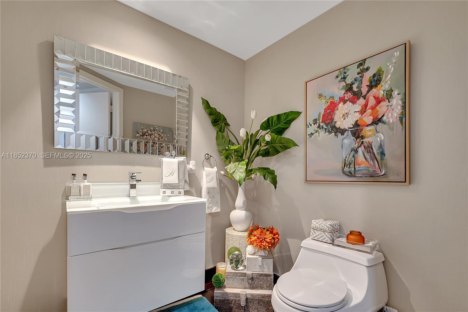 848 Brickell Key Drive, Unit 1906 Miami, FL 33131 - Photo 16 of 18 a bathroom with a sink mirror and toilet