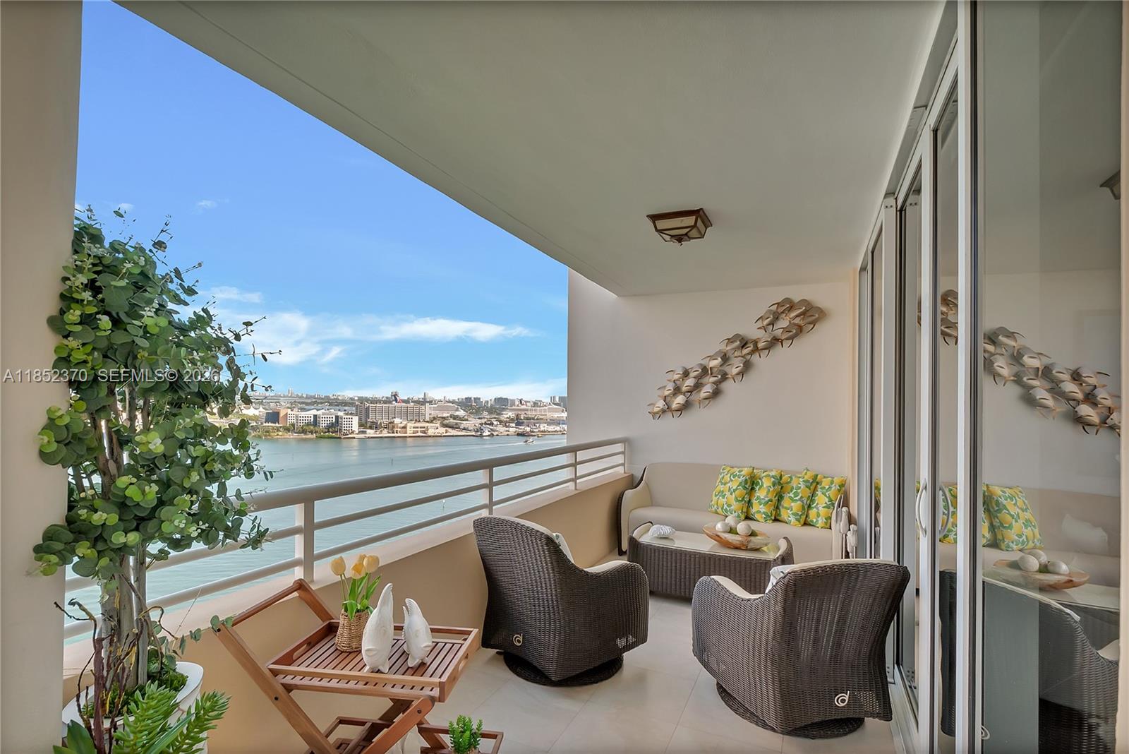 848 Brickell Key Drive, Unit 1906 Miami, FL 33131 - Photo 3 of 24 a view of a balcony with furniture and floor to ceiling window
