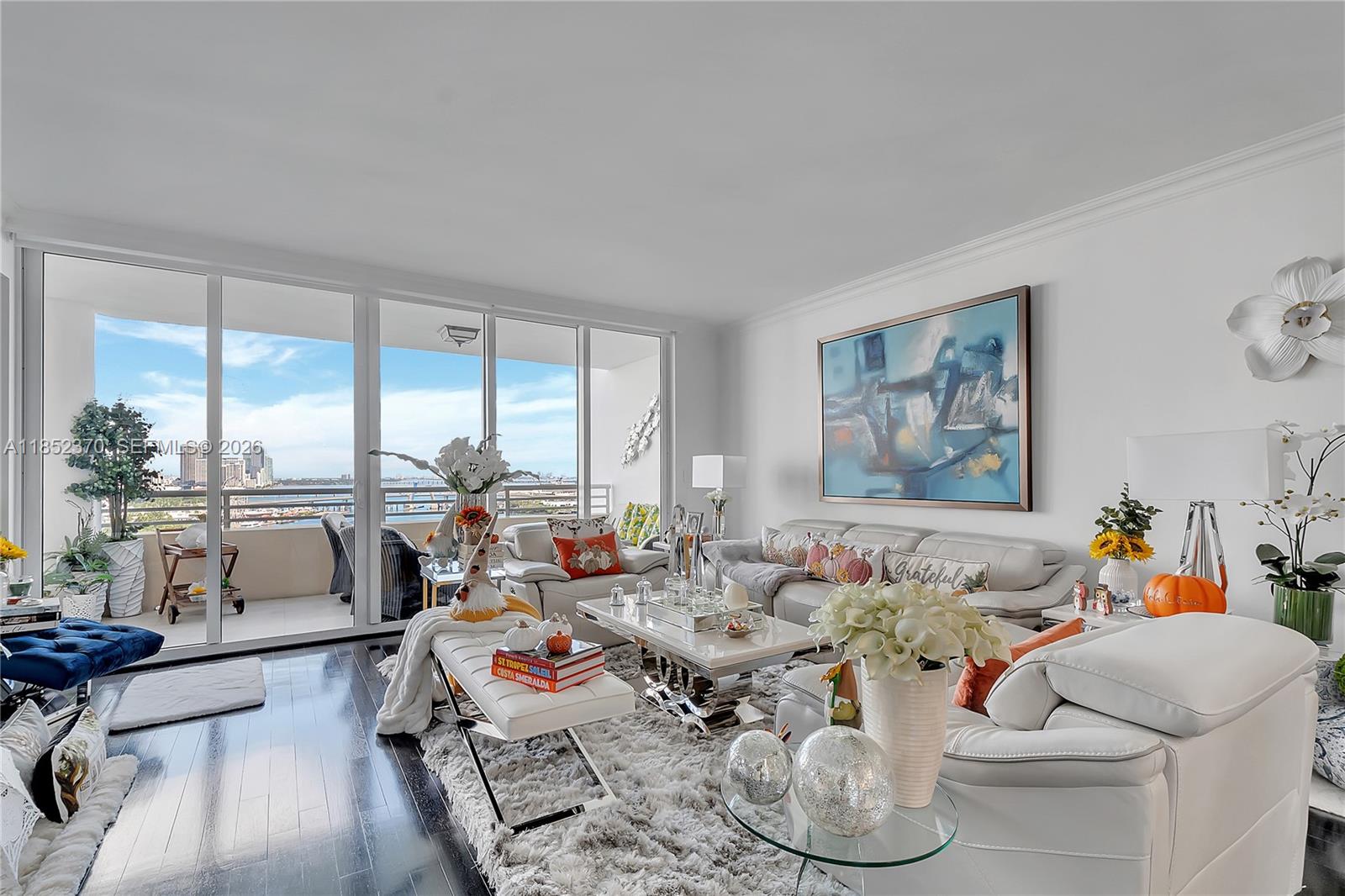 848 Brickell Key Drive, Unit 1906 Miami, FL 33131 - Photo 5 of 24 a very nice looking living room with furniture and a large window