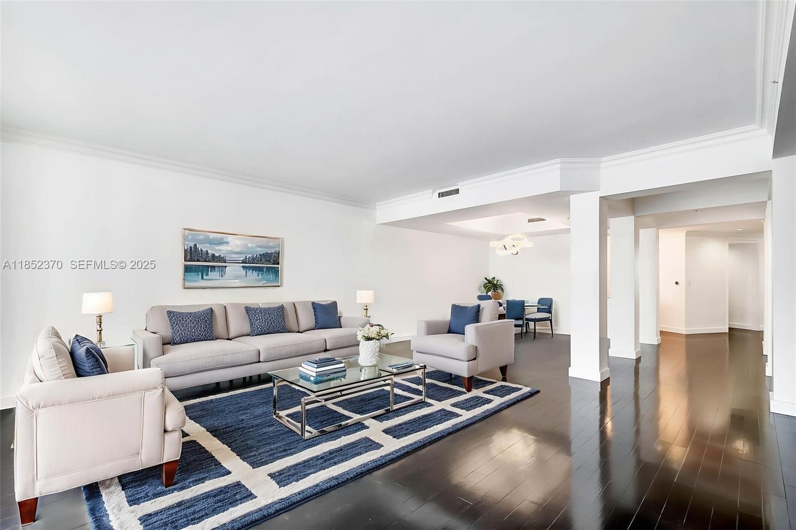 848 Brickell Key Drive, Unit 1906 Miami, FL 33131 - Photo 6 of 18 a living room with furniture rug and wooden floor