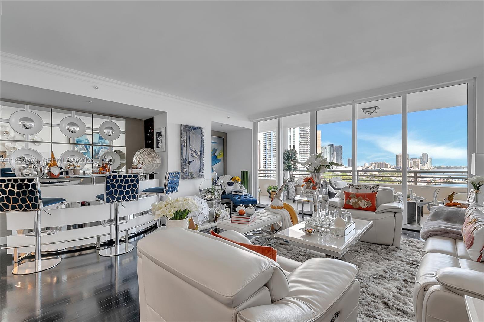 848 Brickell Key Drive, Unit 1906 Miami, FL 33131 - Photo 6 of 24 a living room with furniture and a large window