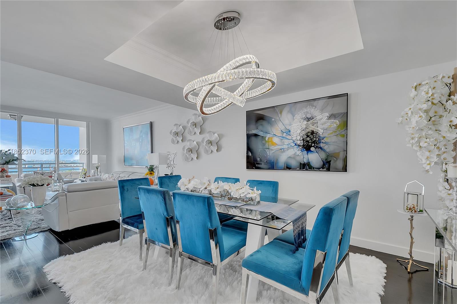 848 Brickell Key Drive, Unit 1906 Miami, FL 33131 - Photo 8 of 24 a view of a dining room with furniture window and wooden floor