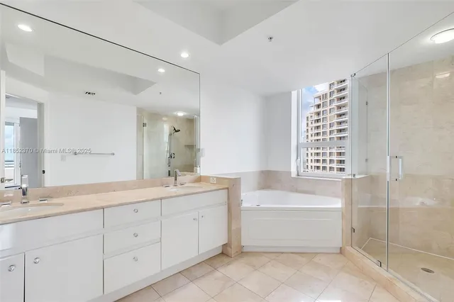 a bathroom with a sink double vanity and a shower