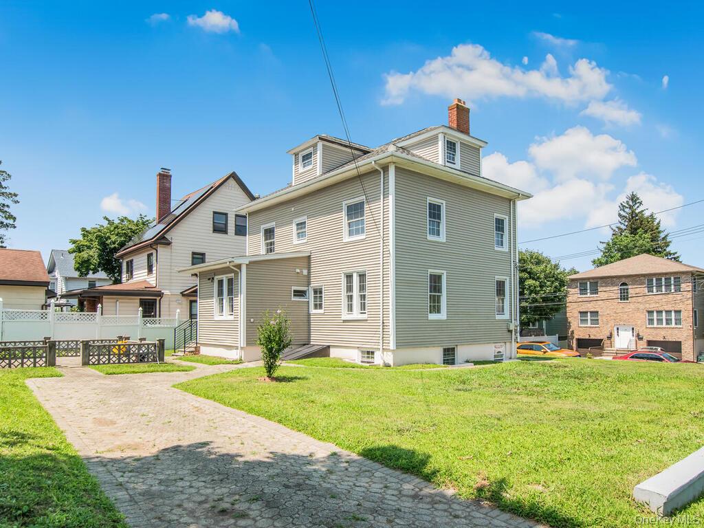 70 Normandy Road Yonkers, NY 10701 - Photo 4 of 26 Three-story residential structure featuring light-toned siding and multiple windows