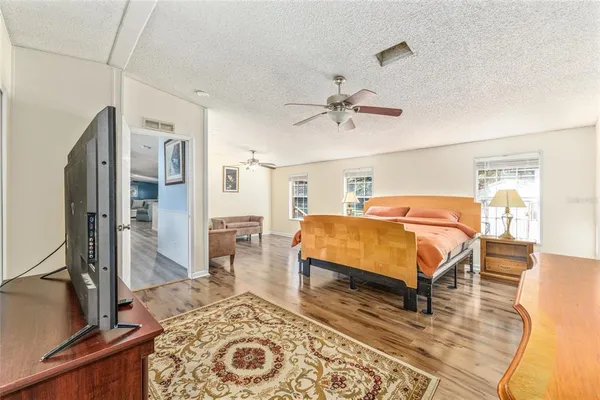 a view of backyard with a large window and wooden floor