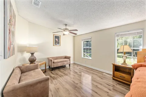a front view of a house with swimming pool having outdoor seating