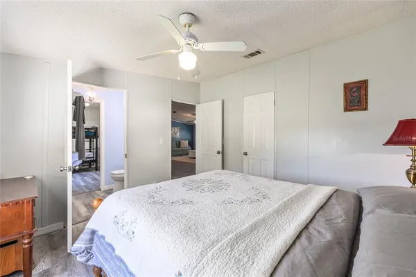 a living room with furniture a flat screen tv and a table