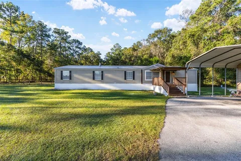 a living room with furniture a fireplace and a chandelier