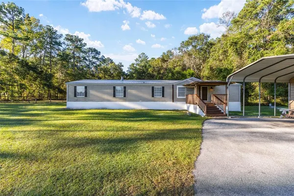 a living room with furniture a fireplace and a chandelier