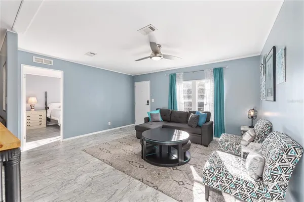 a view of a house with a big yard and a large tree