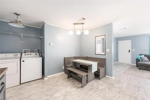 a view of a swimming pool with a yard and large trees